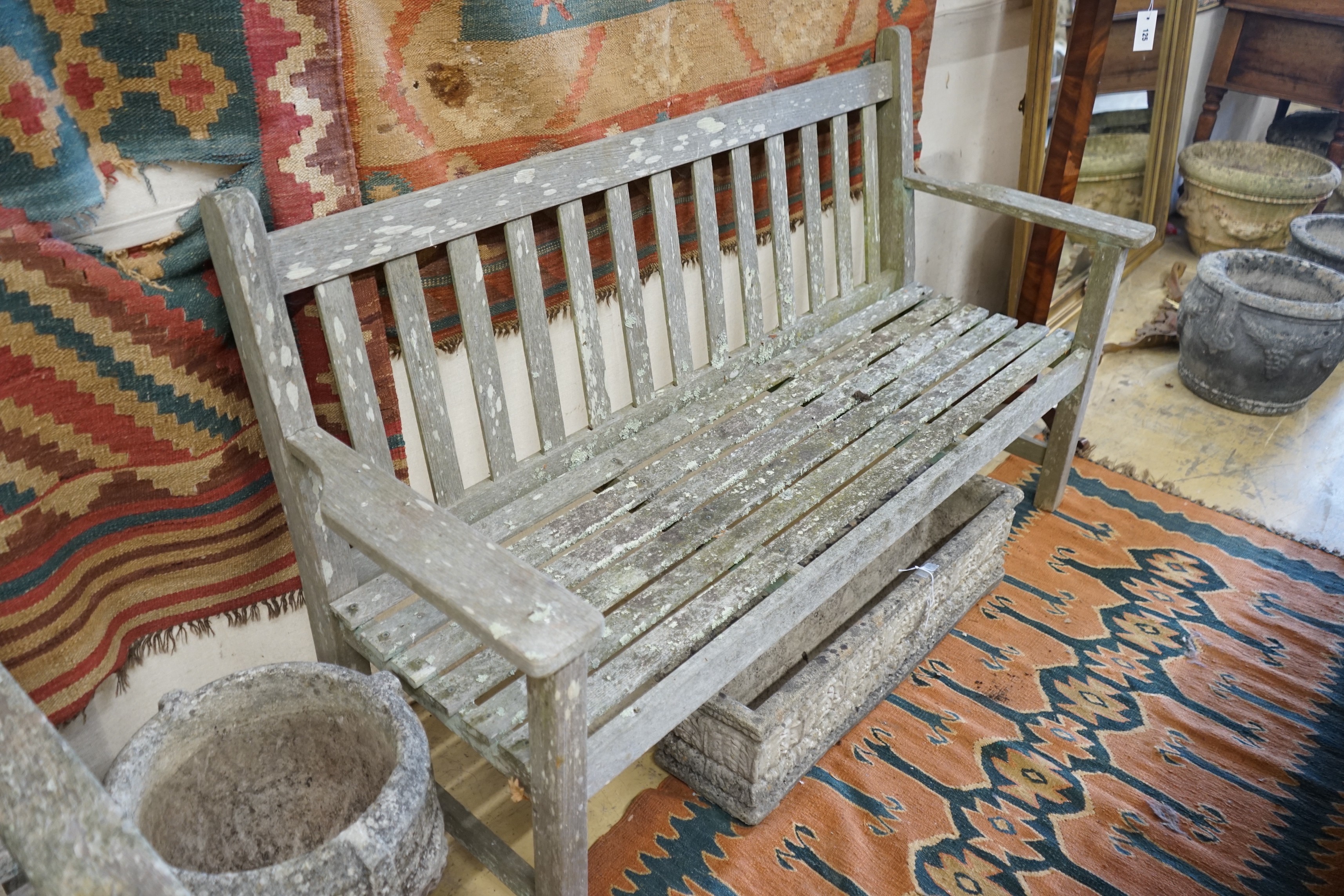 A near pair of weathered slatted teak garden benches, larger length 155cm, depth 56cm, height 90cm